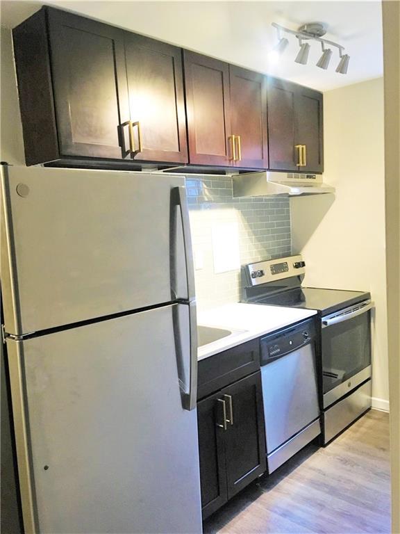 a kitchen with a refrigerator and a stove