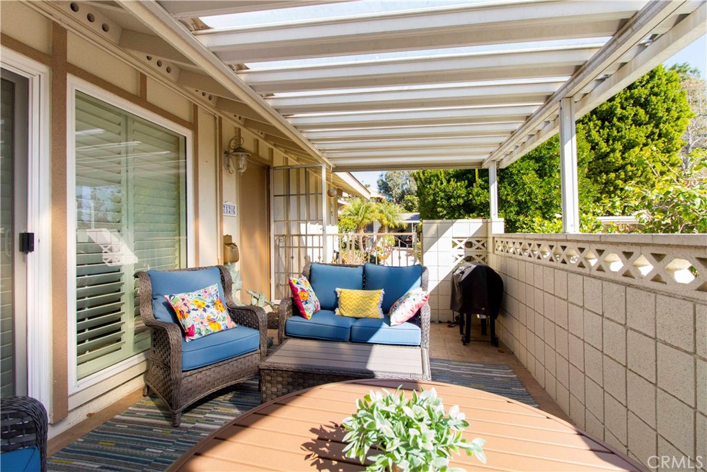 a balcony with furniture and a potted plant