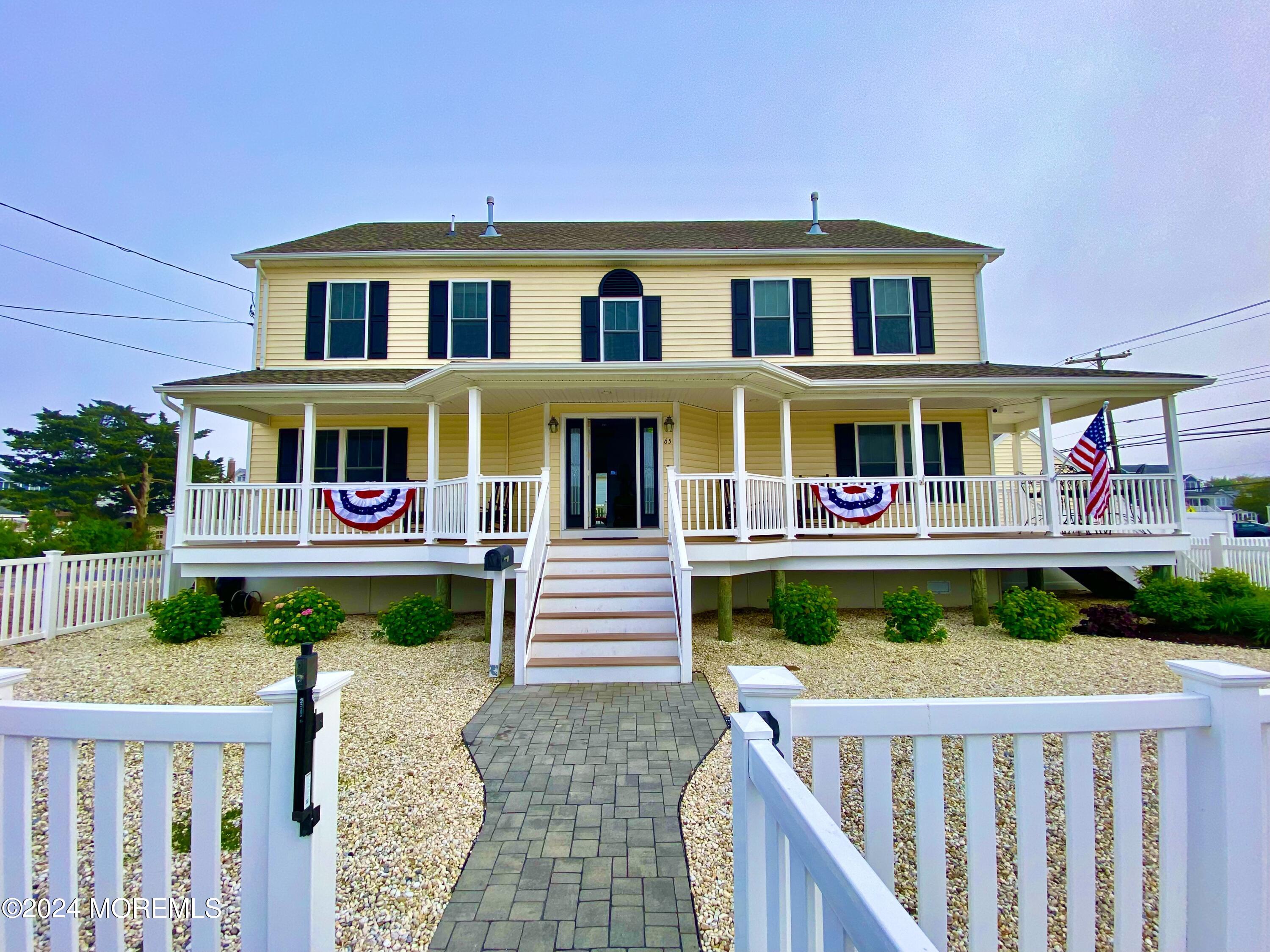 a front view of a house with garden entrance and deck