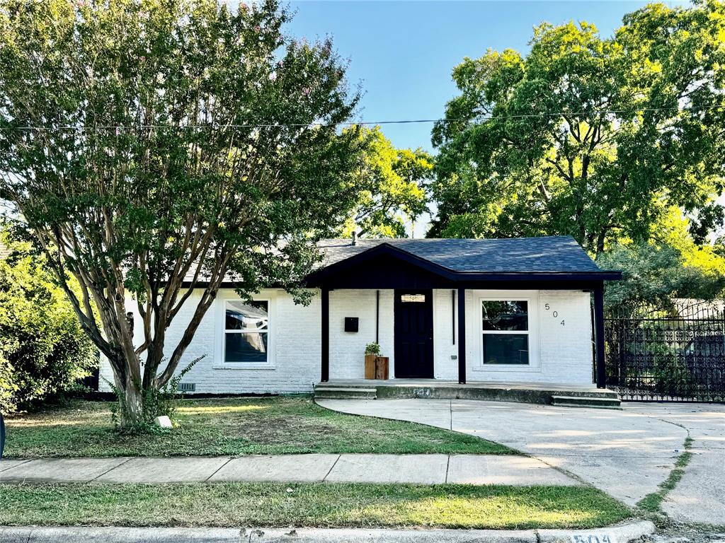 a house that has a tree in front of the house