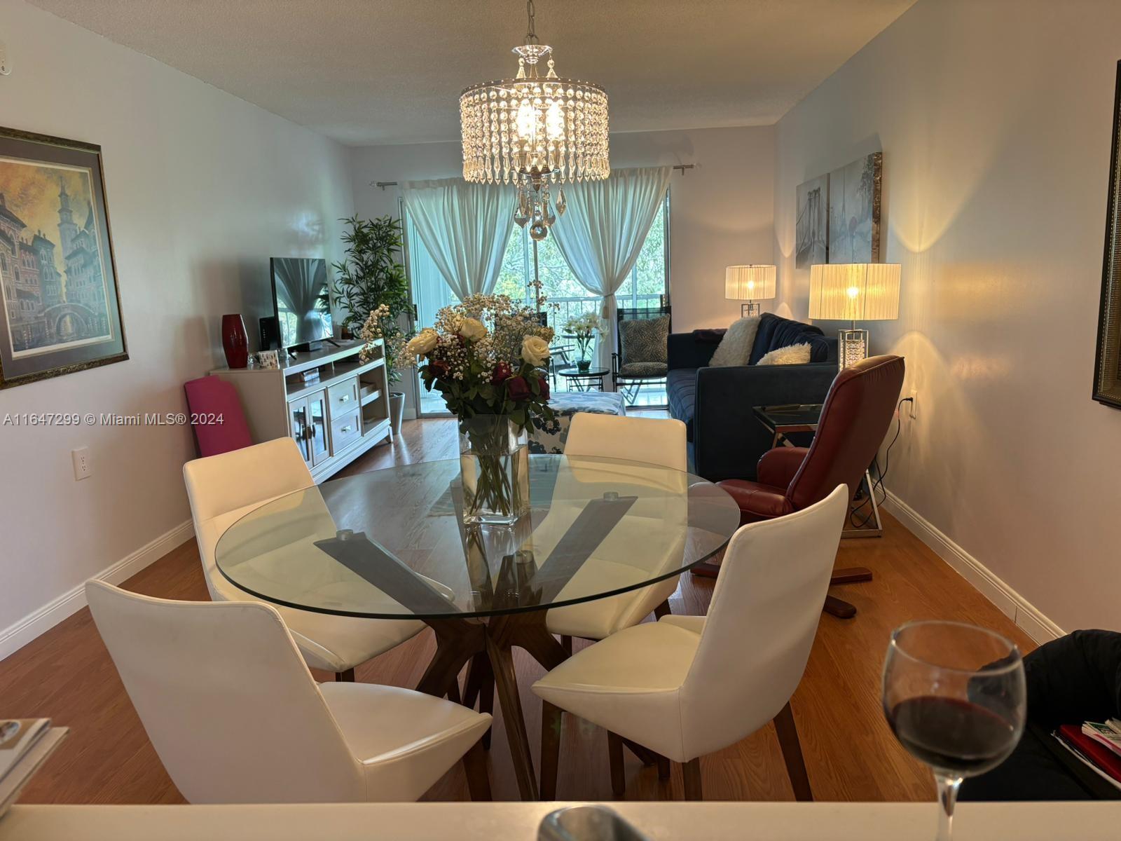 a view of a dining room with furniture and chandelier