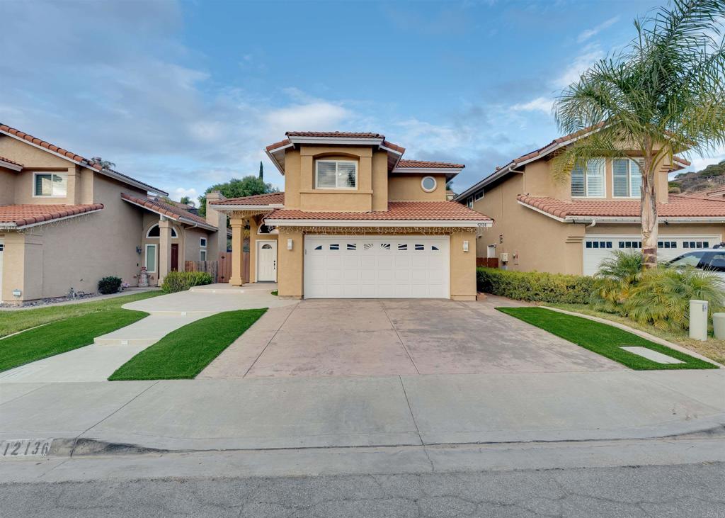 a front view of a house with a yard and garage