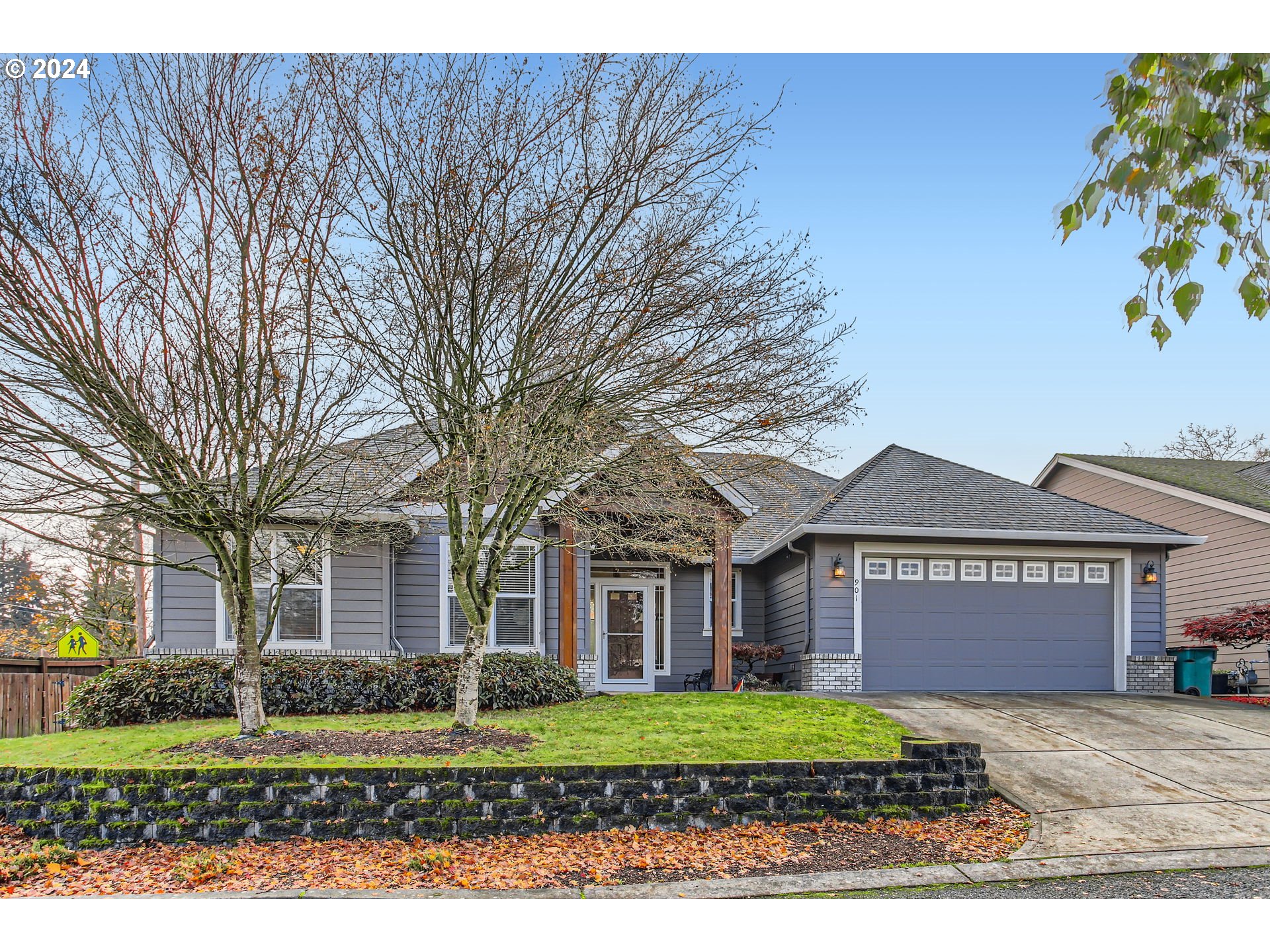 a front view of a house with a garden