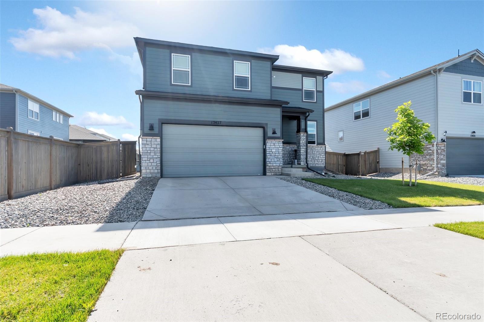 a front view of a house with a yard and garage