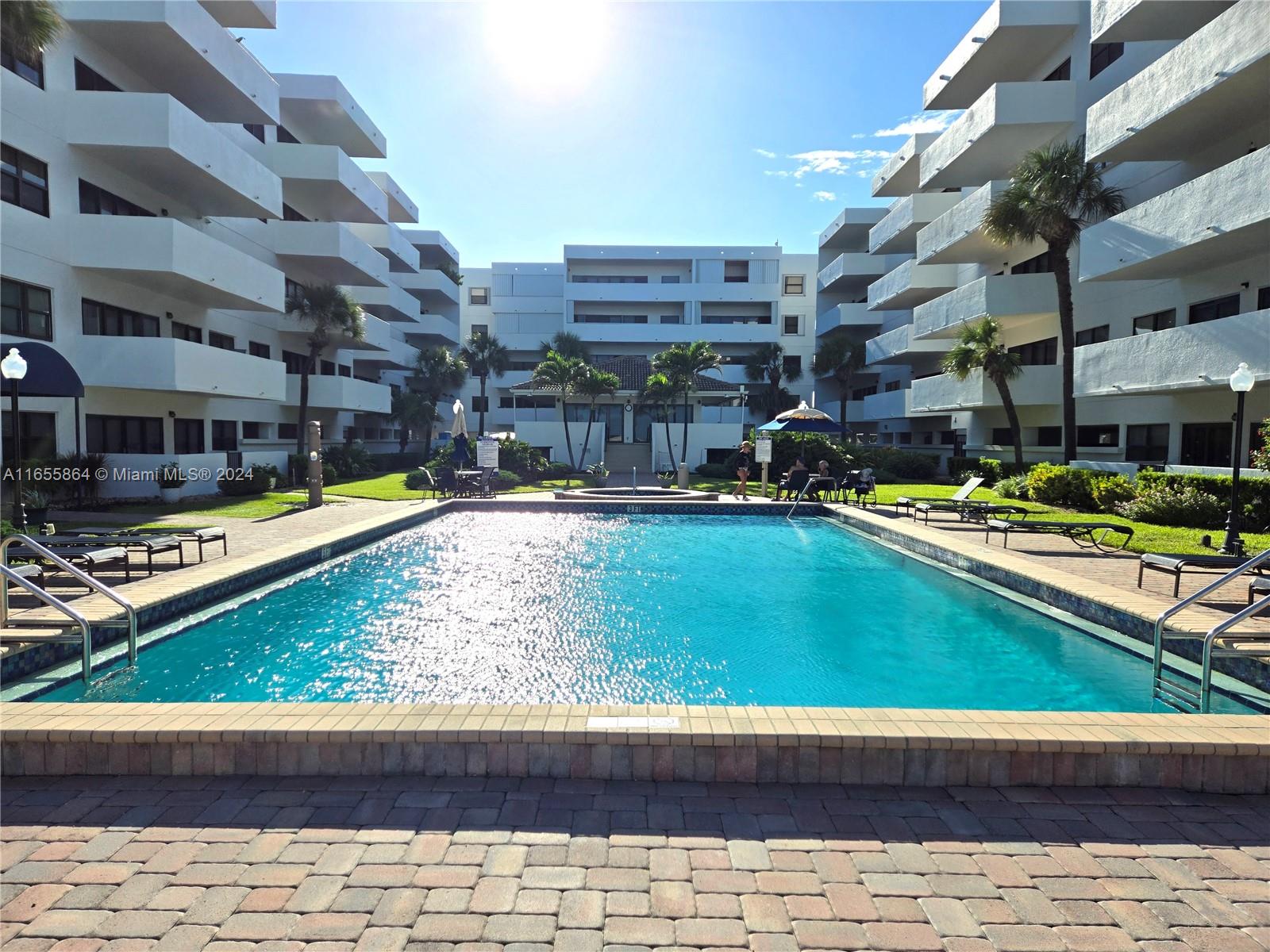 a view of a swimming pool with outdoor seating