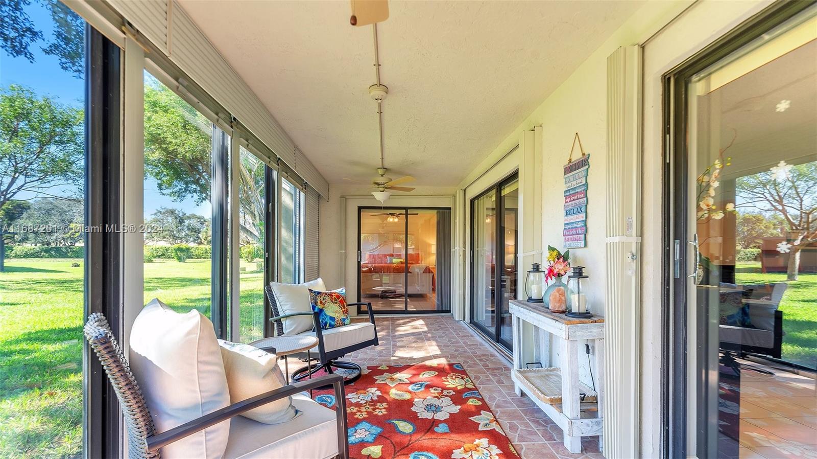 a living room with furniture and floor to ceiling windows