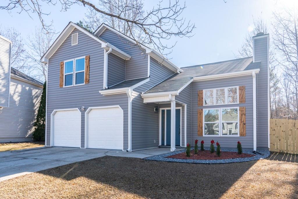 a front view of a house with outdoor seating and covered with snow