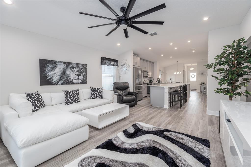 a living room with furniture and a chandelier