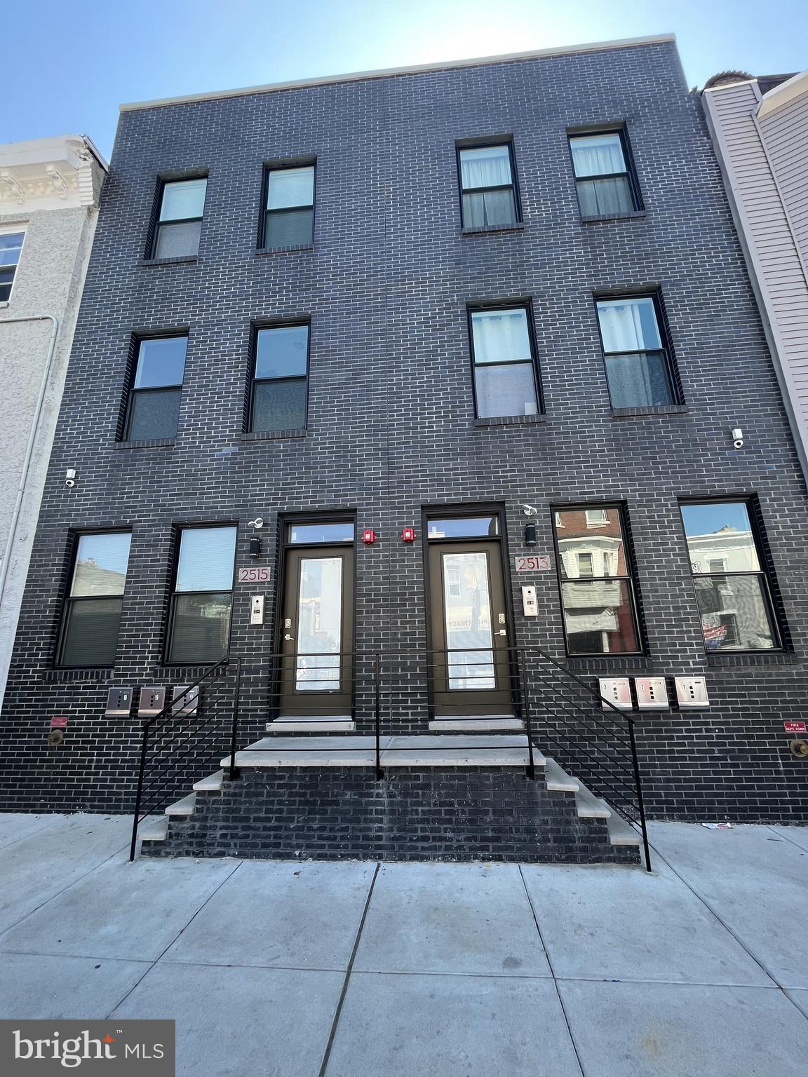 a front view of a brick building with many windows