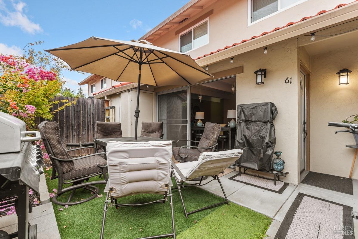 a view of a chairs and table in the patio