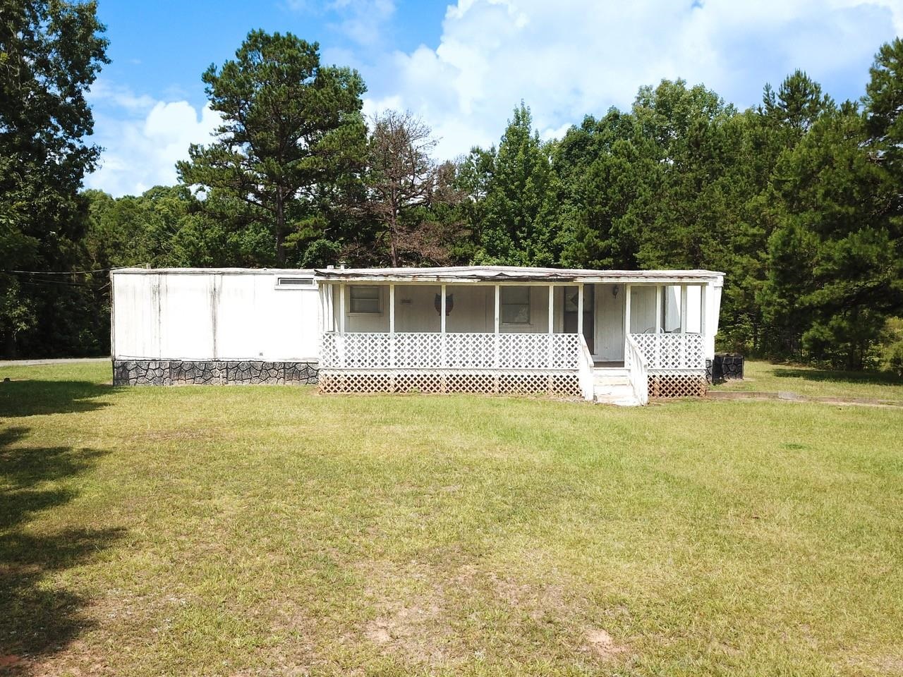 a view of a house with a backyard and a garden