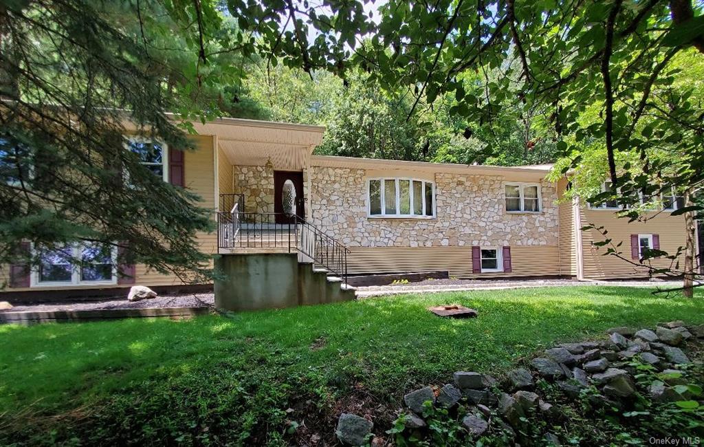 a front view of house with yard and green space