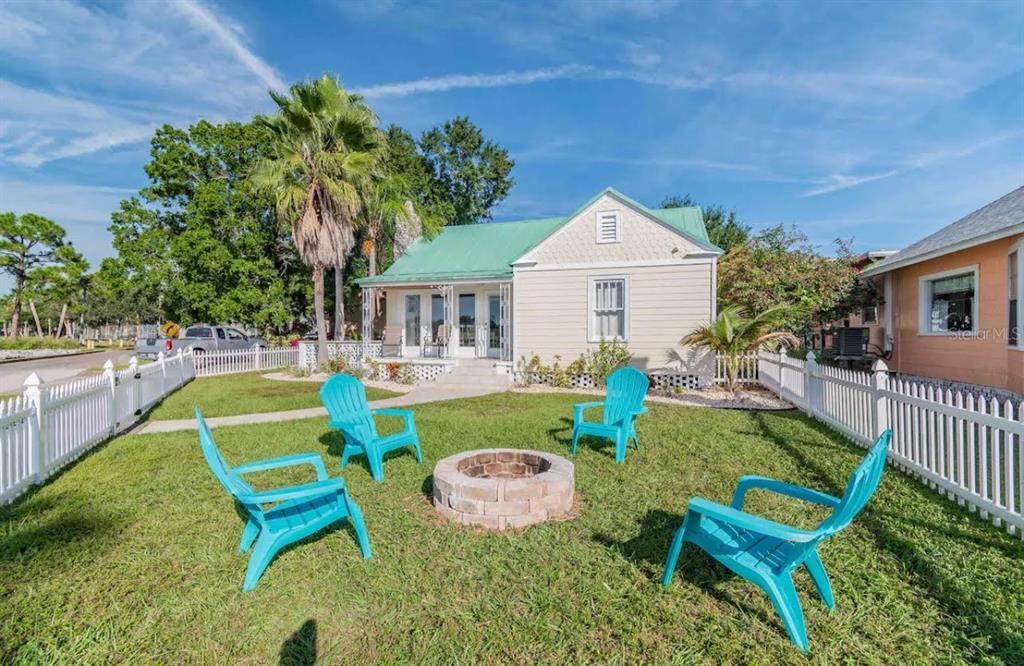 a view of a chair and table in the backyard of the house