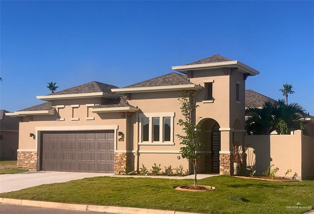 a front view of house with a garden