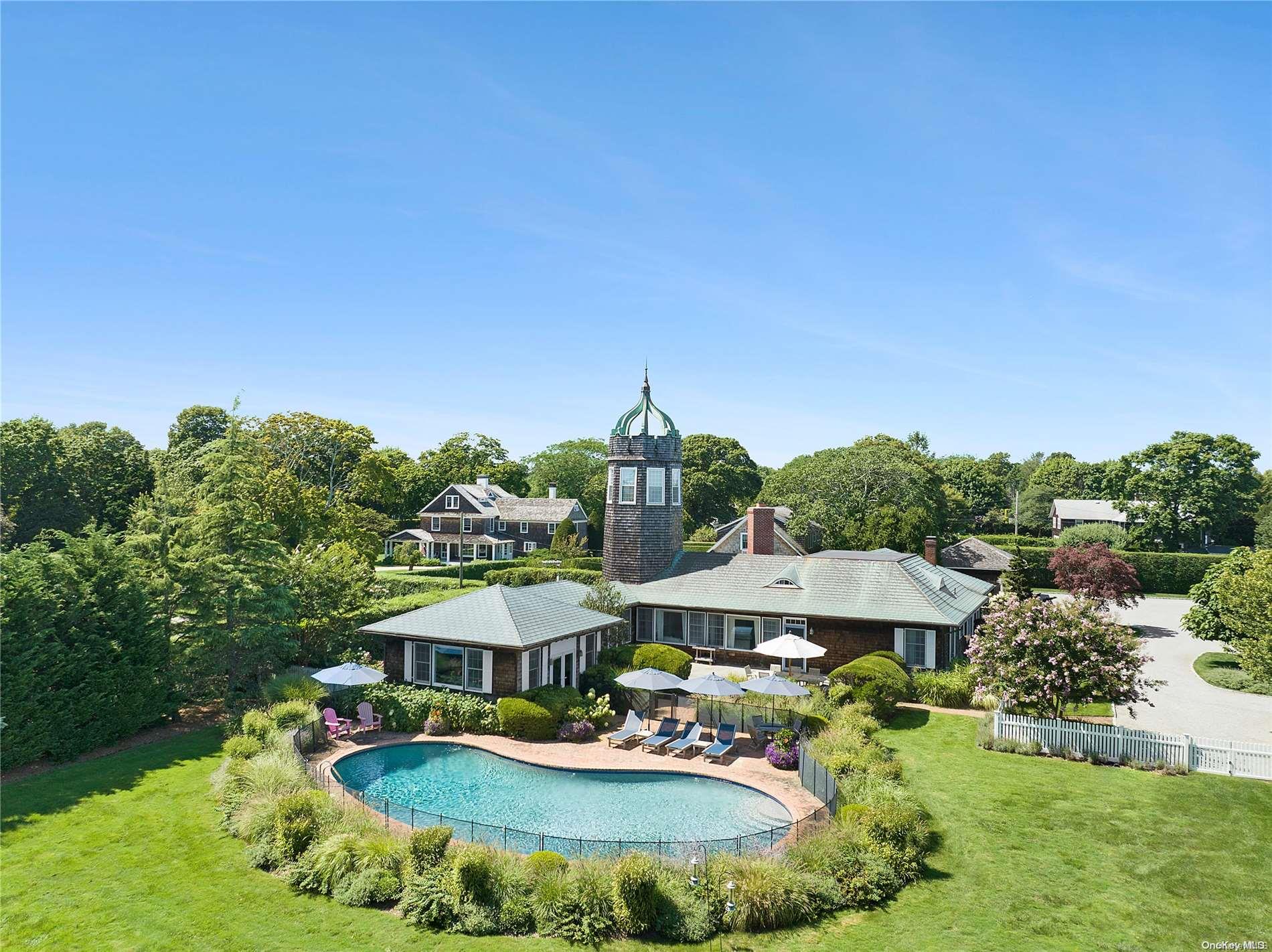 a aerial view of a house with yard swimming pool and outdoor seating