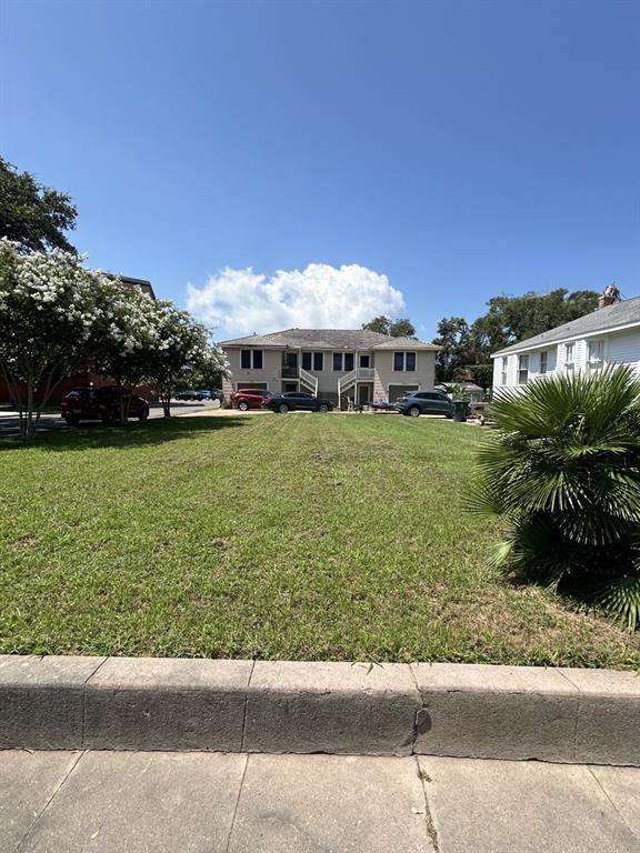 a front view of a house with a garden and yard