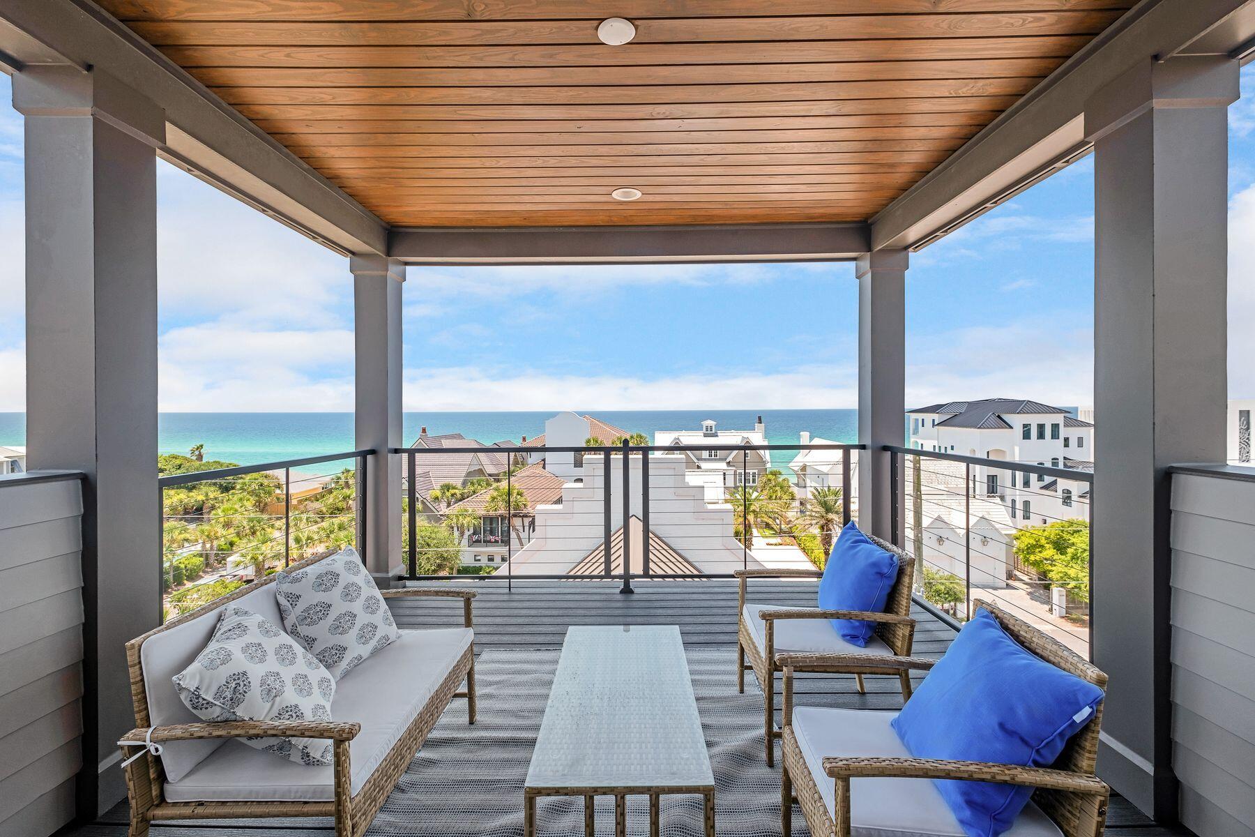 a living room with furniture and floor to ceiling windows