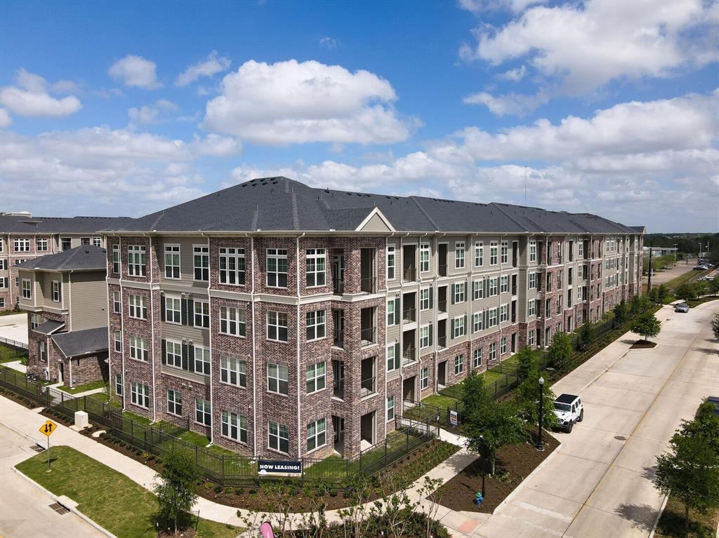 a view of a large building with a yard