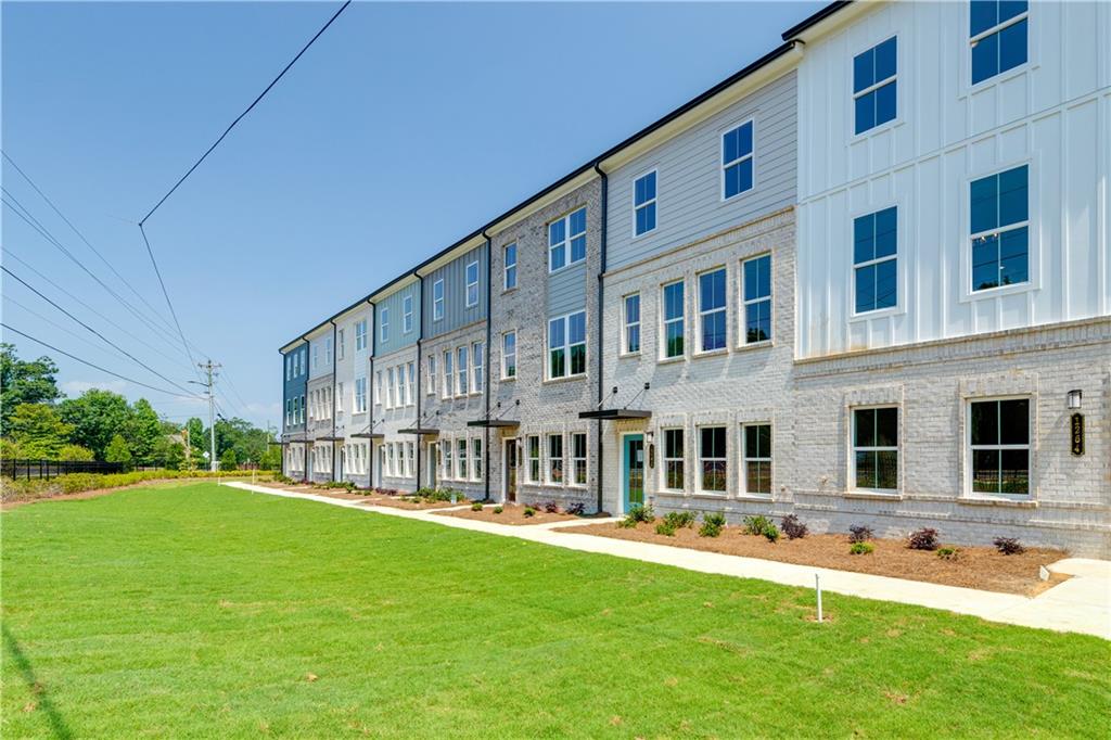 a front view of a building with a yard