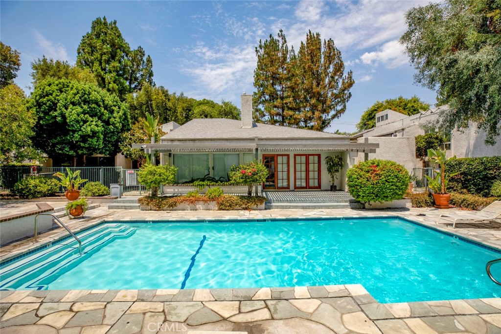 a view of a house with a yard patio and fire pit