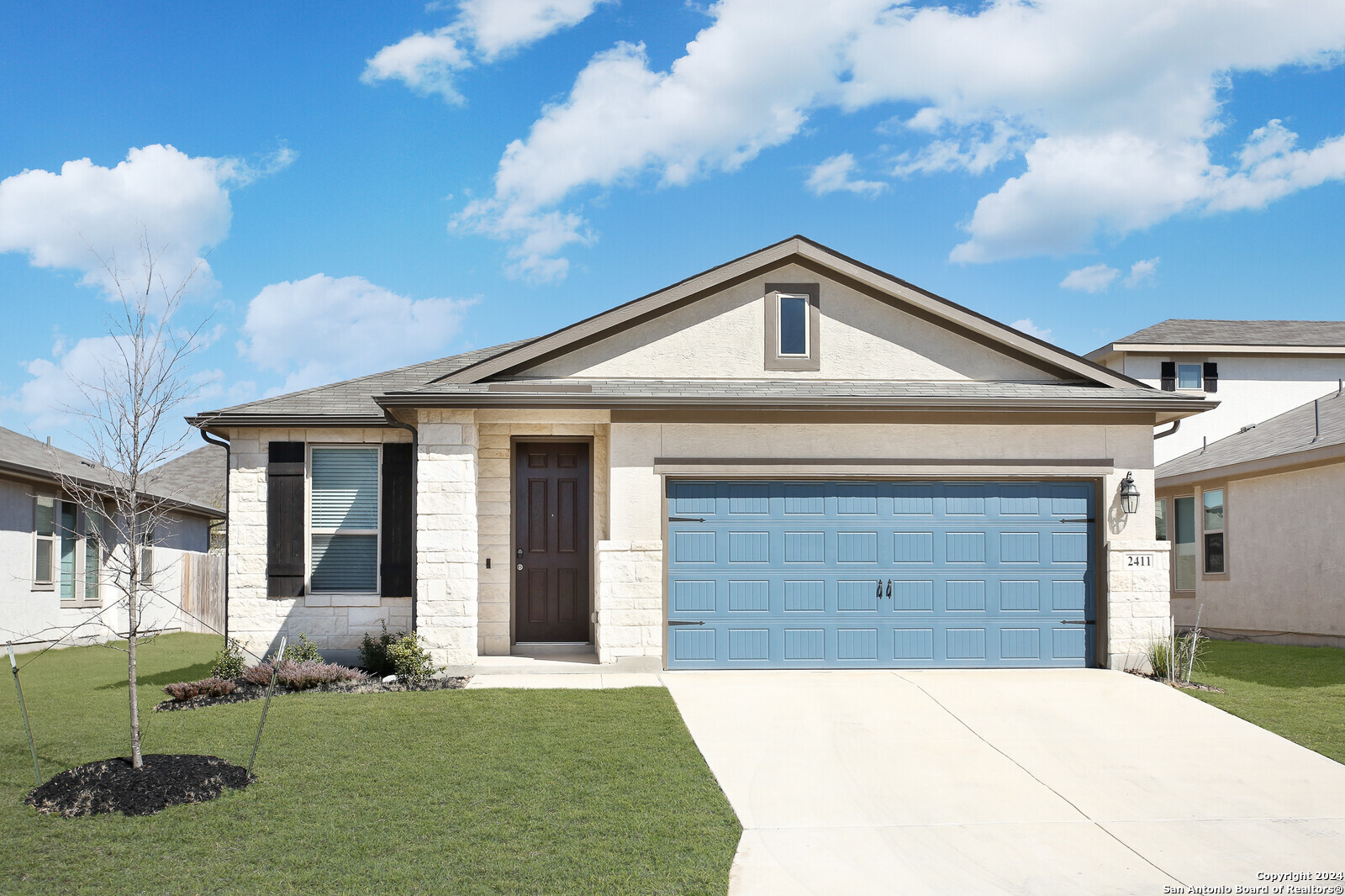 a front view of a house with garden