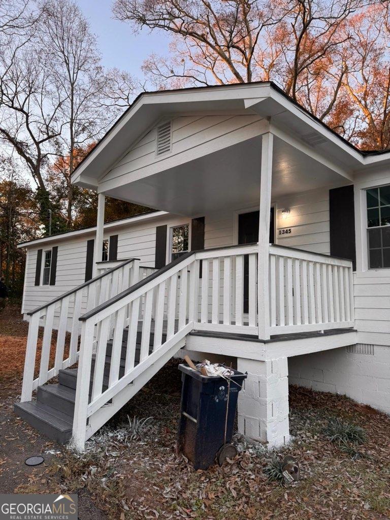 a view of a house with wooden fence