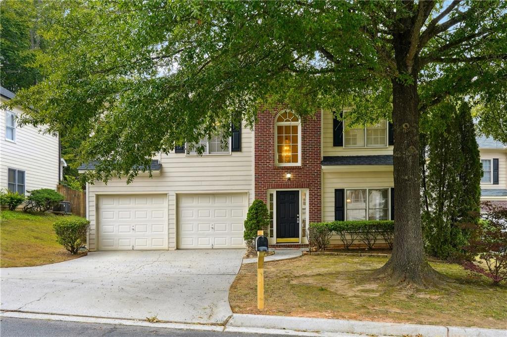 front view of a house with a tree