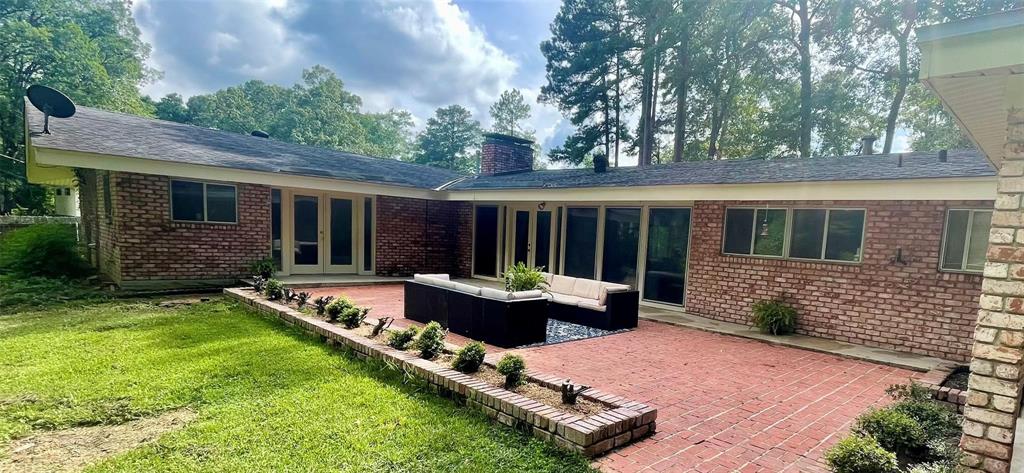 a view of a house with backyard sitting area and garden