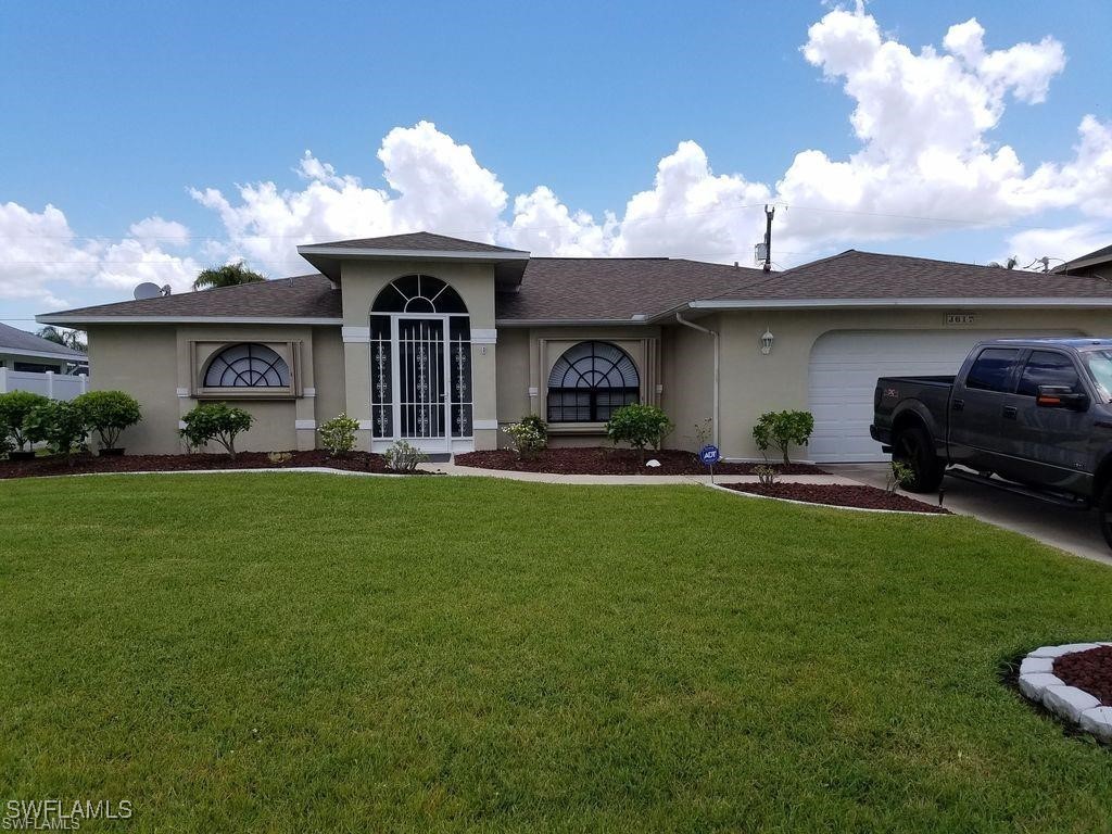 a front view of a house with garden