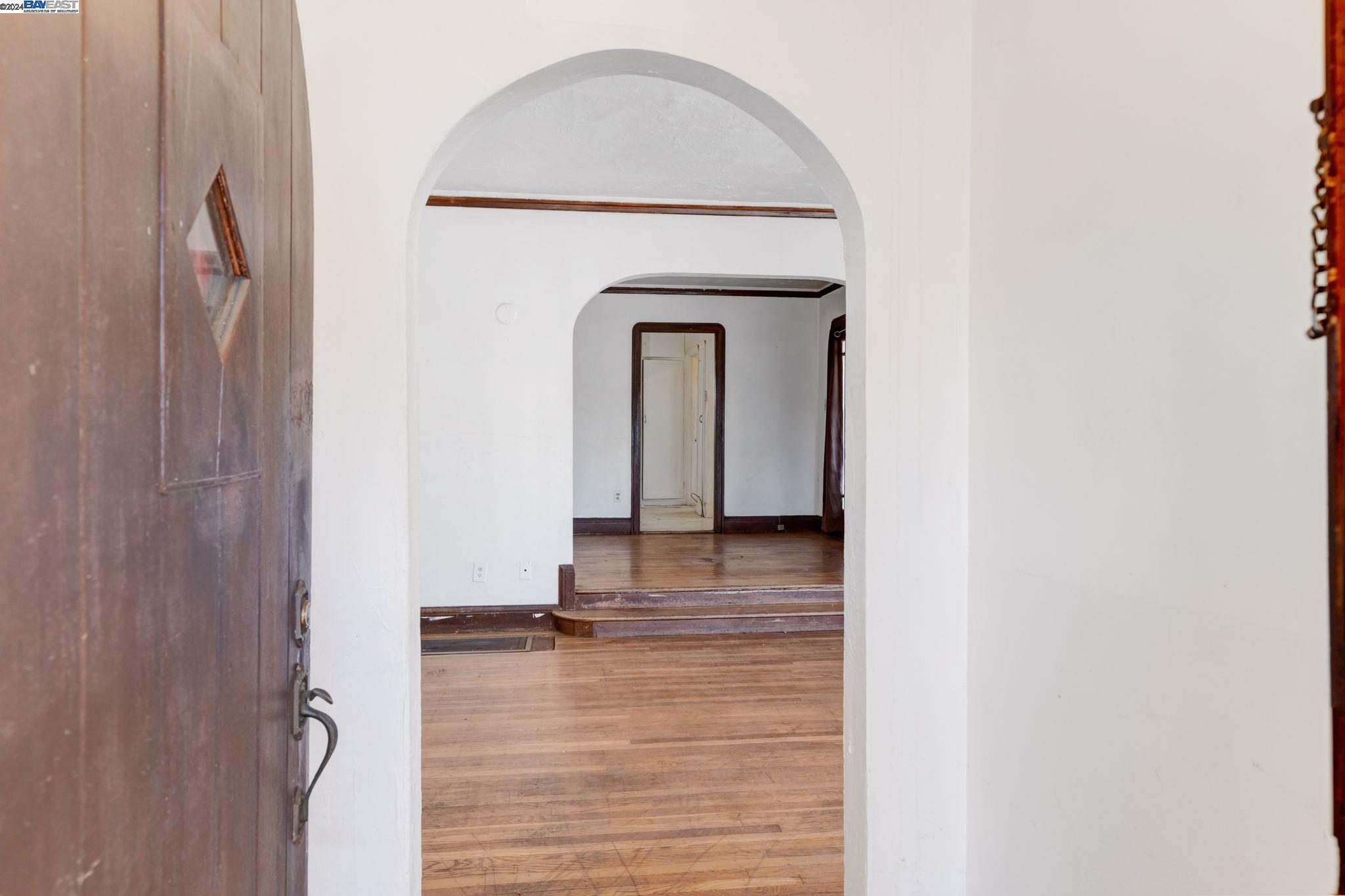 a view of a livingroom with wooden floor and a staircase