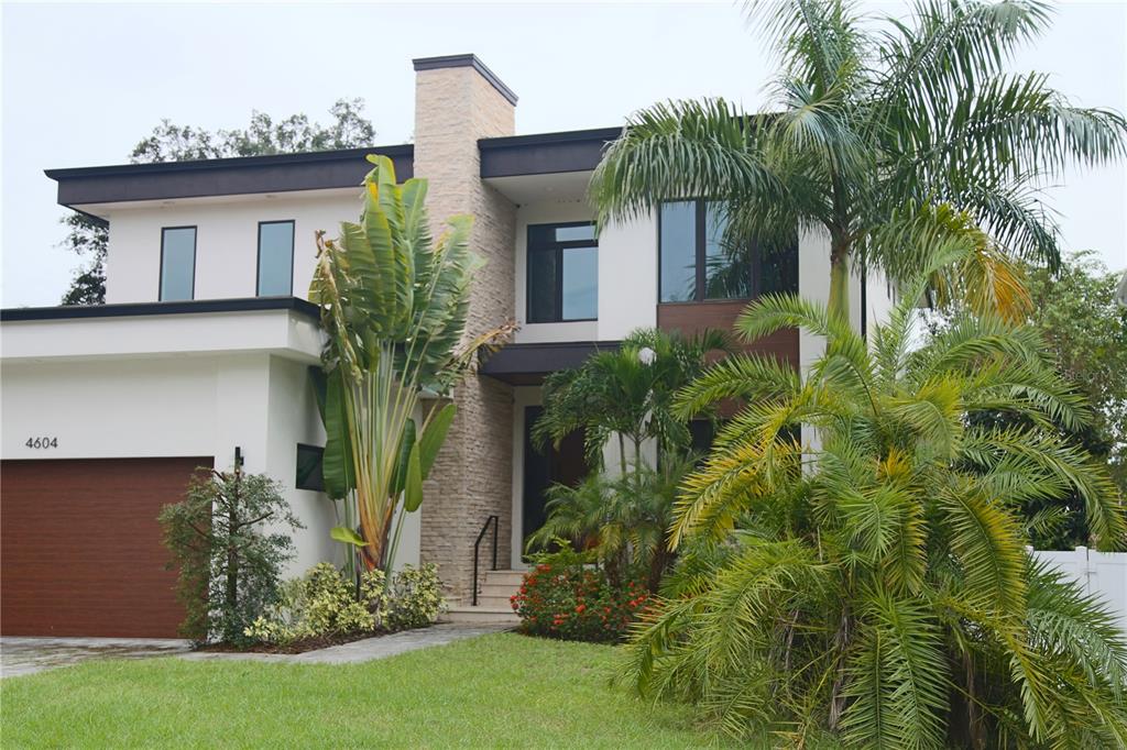 a front view of house with yard and green space