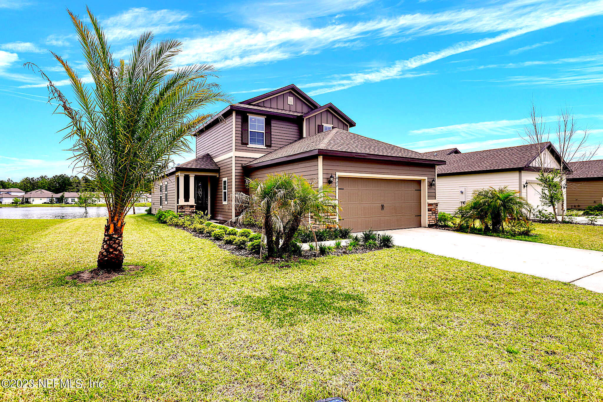 a view of a house with a yard and sitting area