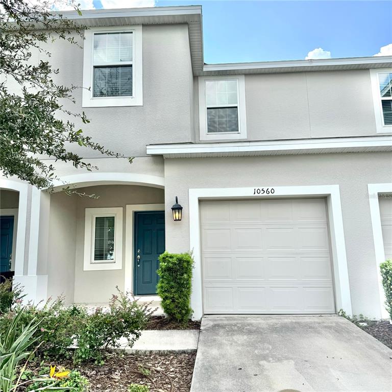 a front view of a house with garage