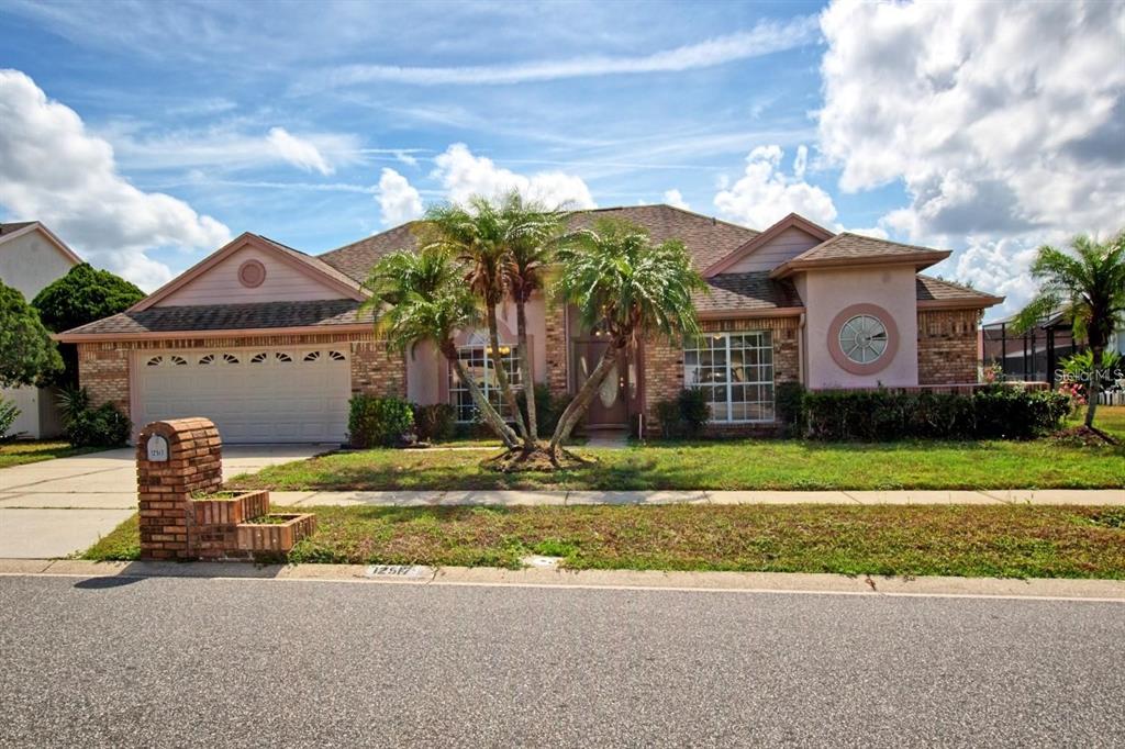 a front view of a house with a yard and garage