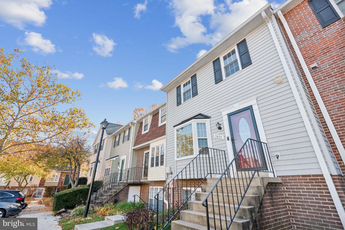 a front view of a multi story residential apartment building with a yard