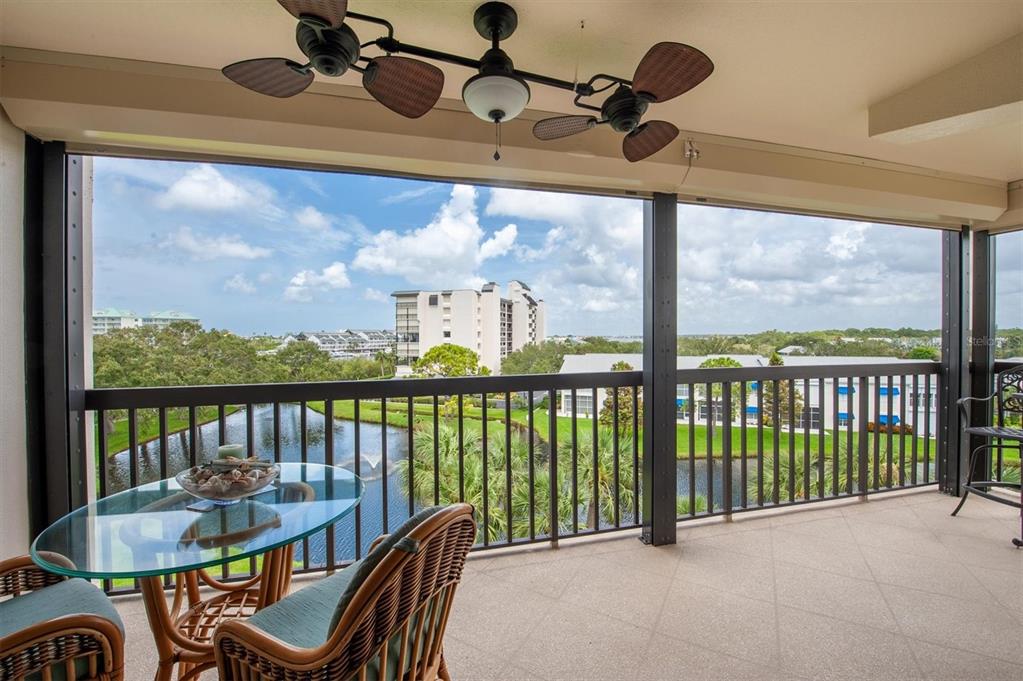 a view of a balcony dining table and chairs