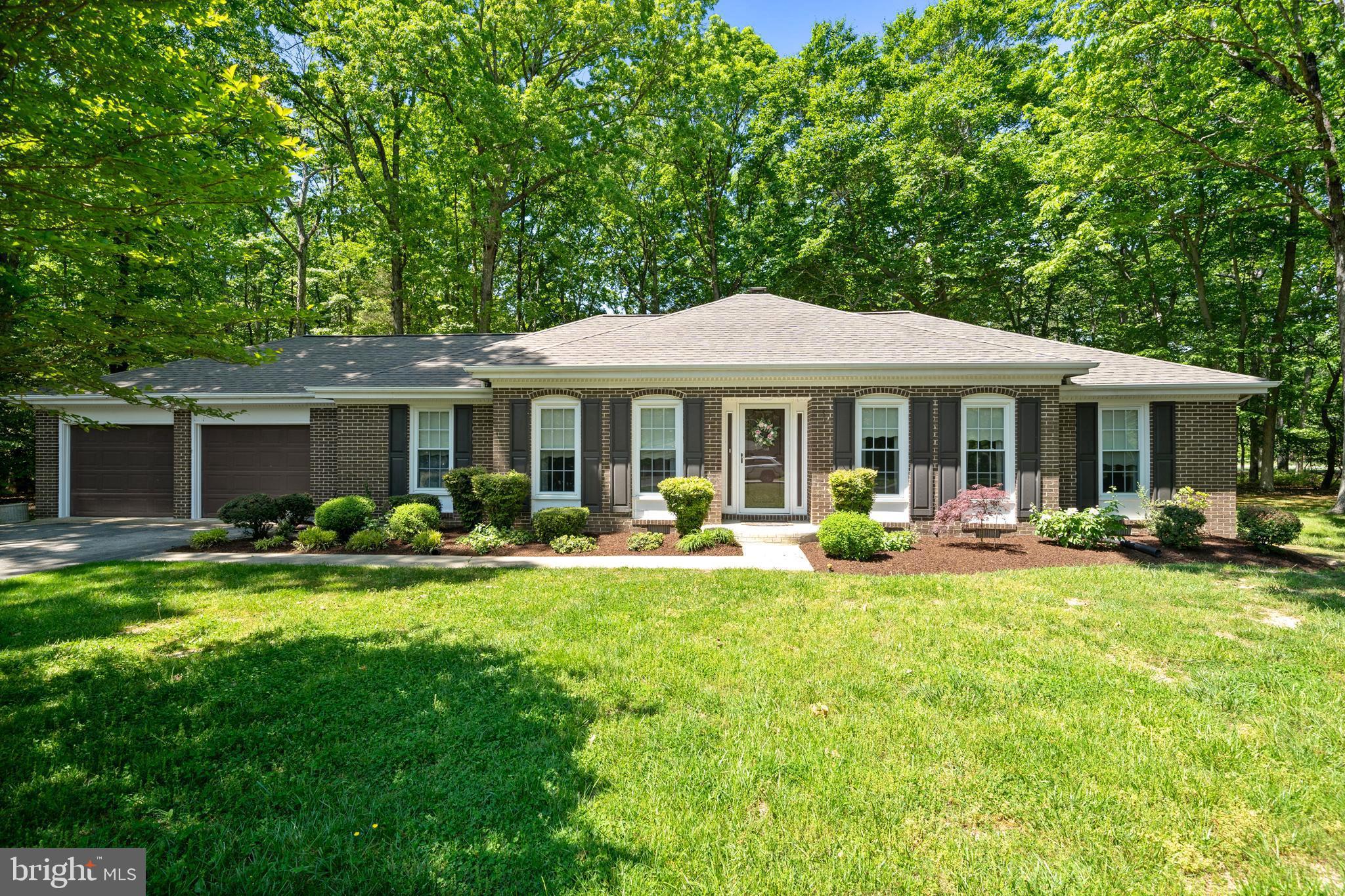 a front view of a house with swimming pool and porch with furniture