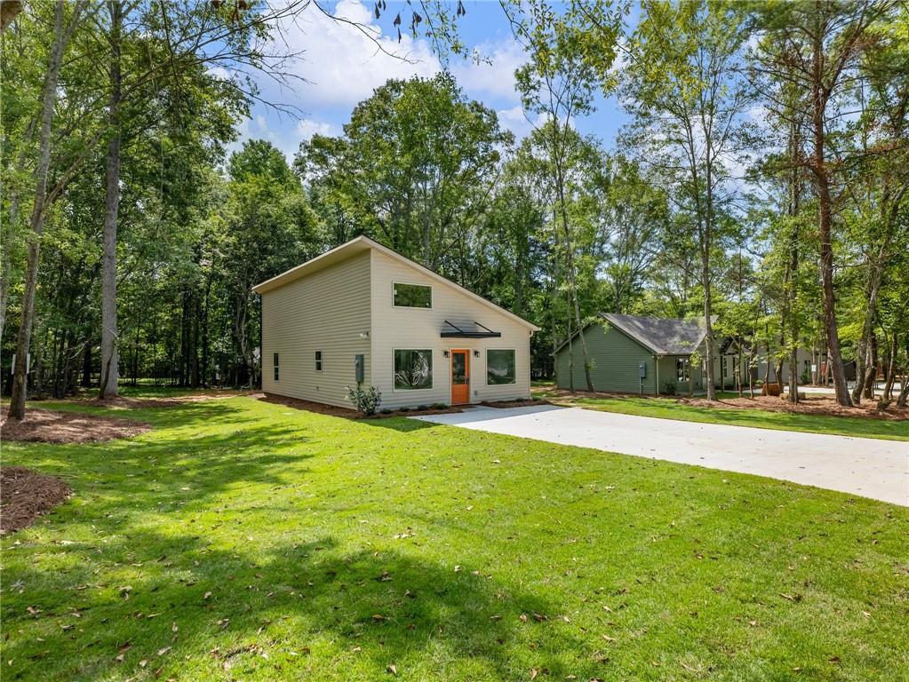 a house that has a big yard with large trees