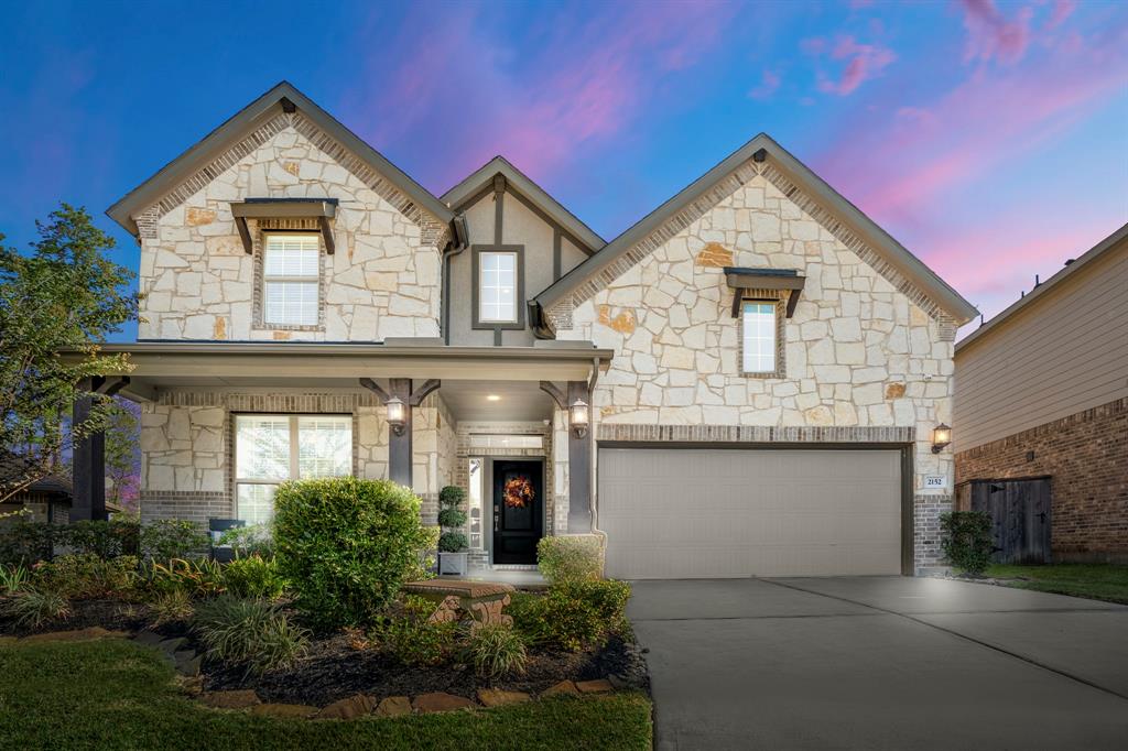 a front view of a house with garage