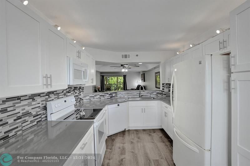 a kitchen with a sink stove and refrigerator