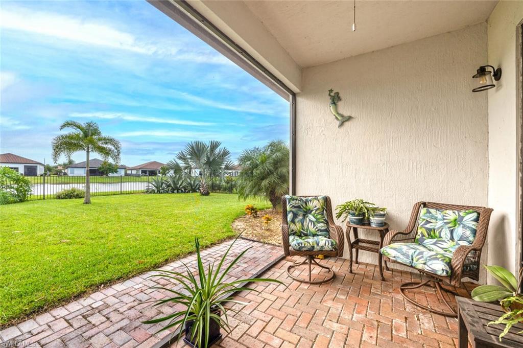 a view of a chairs and table in patio with a yard