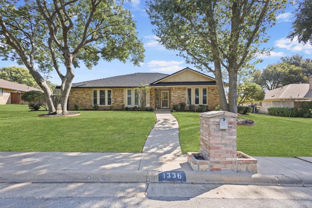 Single story home featuring a front lawn