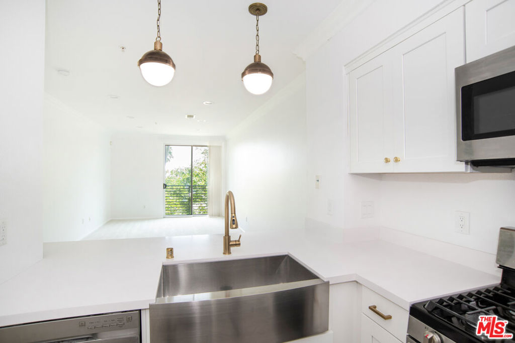 a kitchen with a sink and a stove