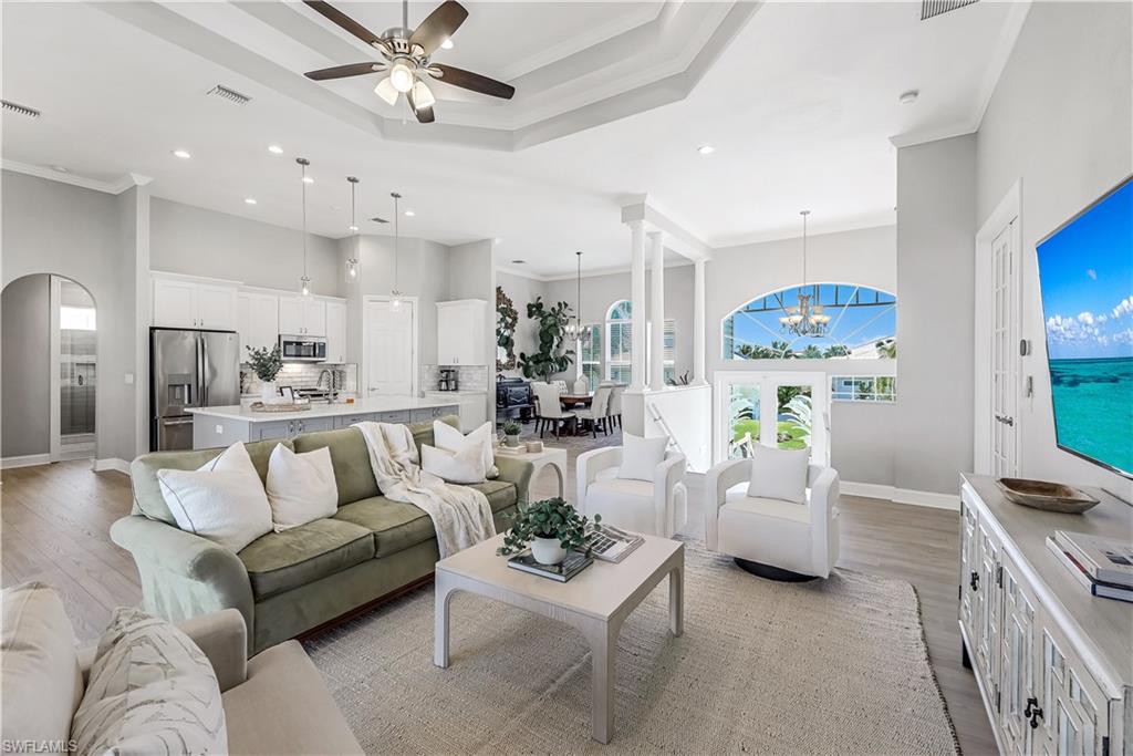 a living room with furniture and a chandelier