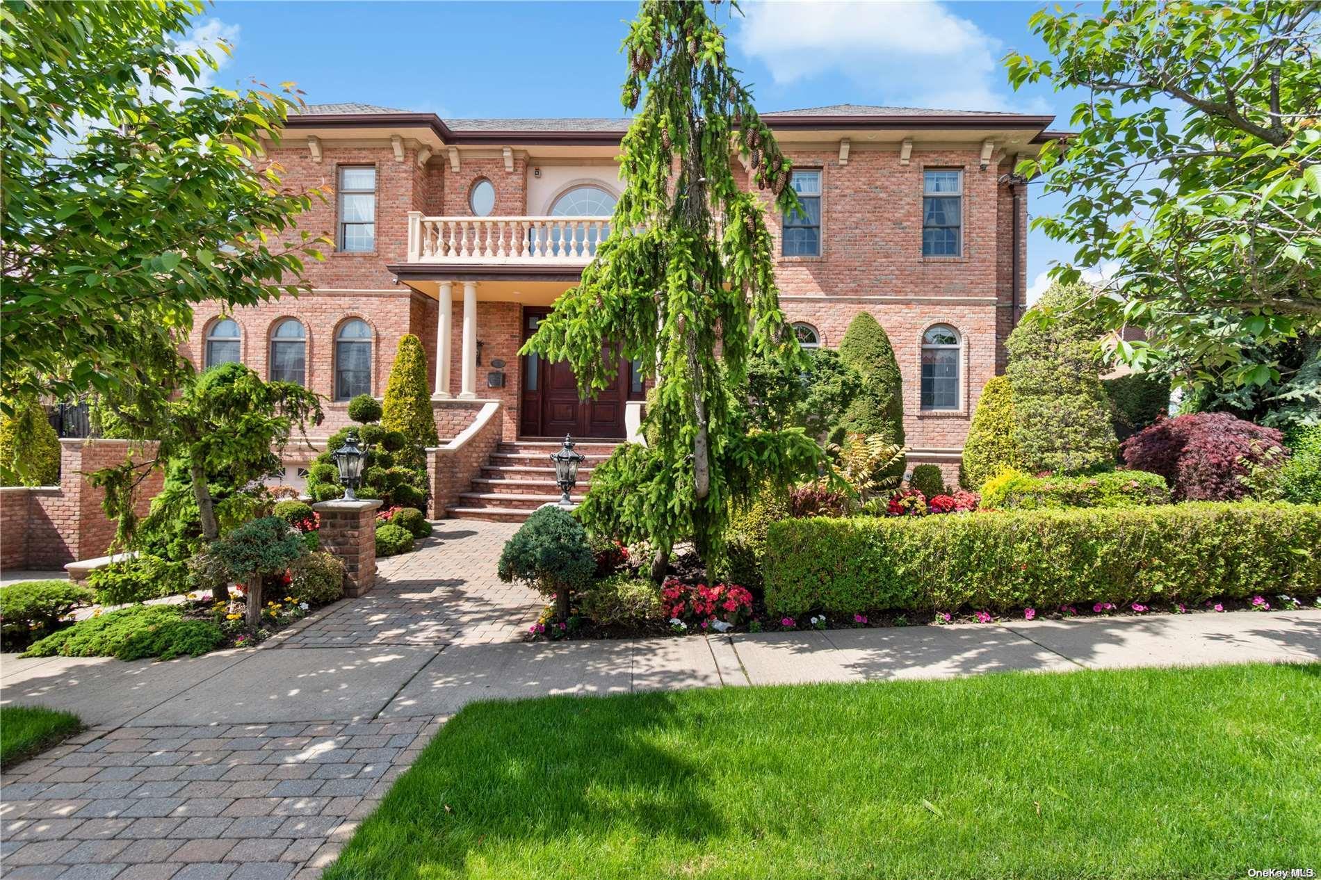 a front view of a house with a yard and outdoor seating