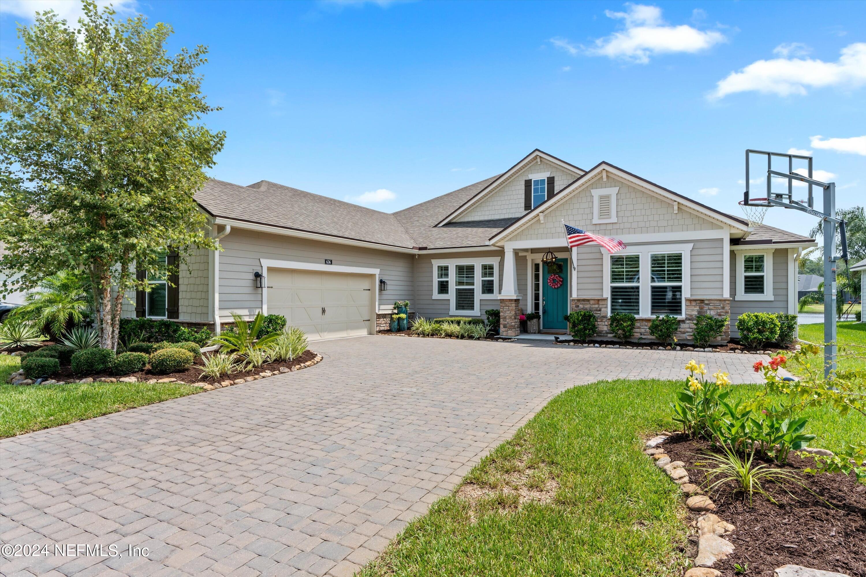 a front view of a house with a yard and porch