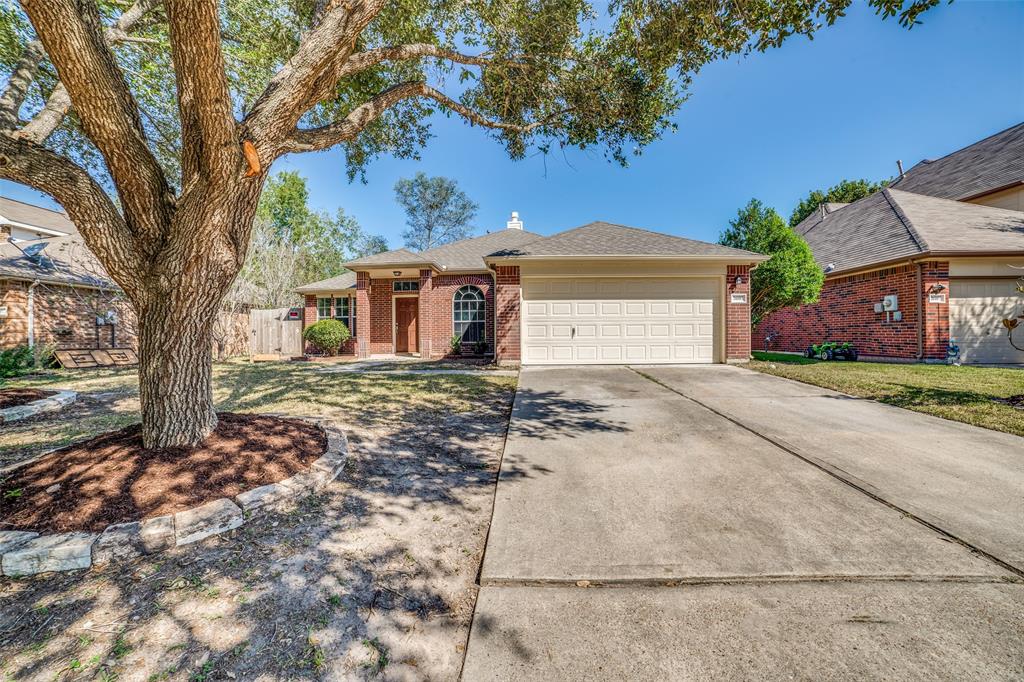 front view of a house with a tree