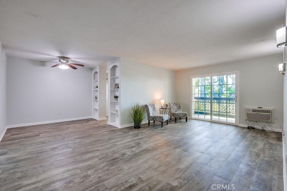 a view of a livingroom with hardwood floor and a large window