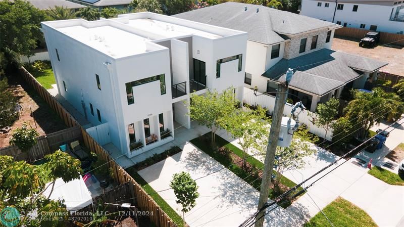 an aerial view of a house with a yard