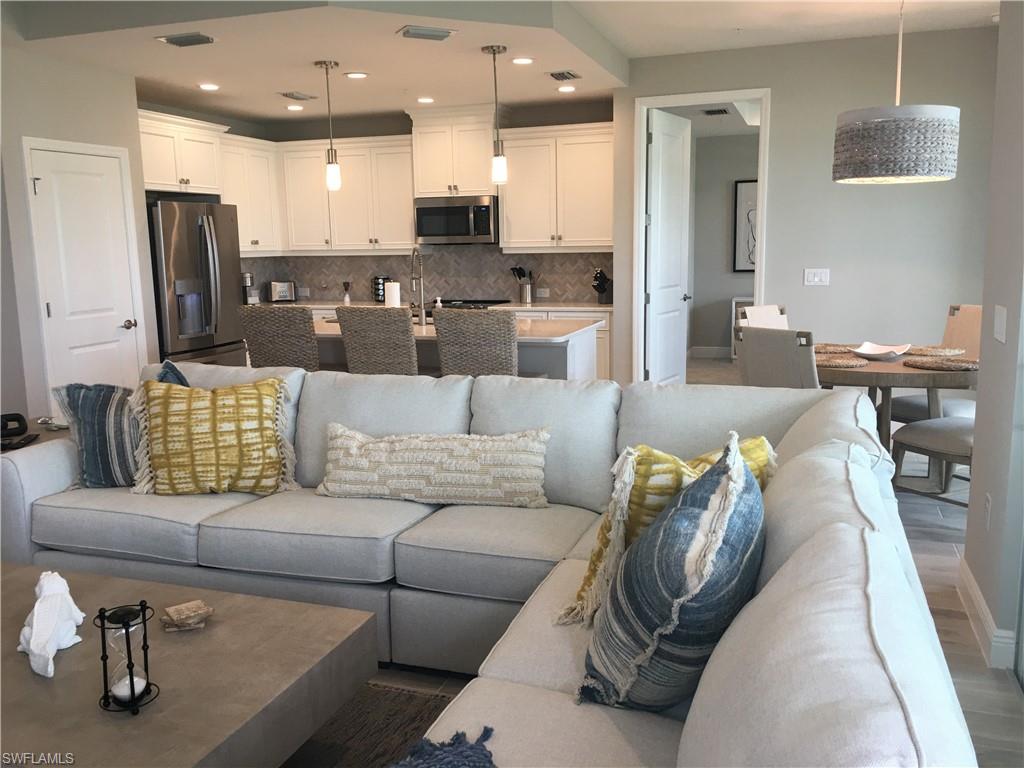 a living room with furniture and kitchen view